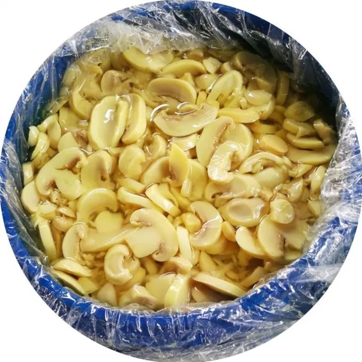 Sliced champignon white mushroom in brine in drums