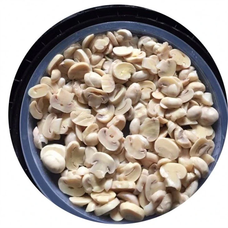 Sliced white champignon in salted water in barrel
